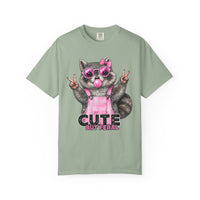 Cute But Feral, Raccoon in Pink Bibs - Comfort Colors | Trendy Women's T-Shirt. Direct to Garment. Printed & Shipped in the USA. Unisex Sizes.