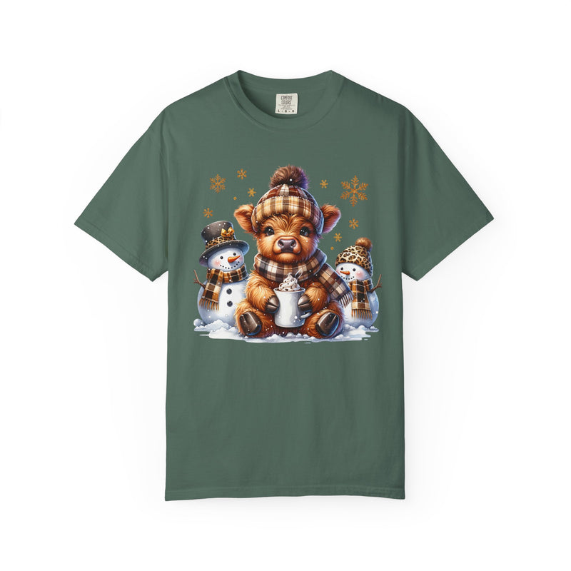Cute Highland Cow with Snowmen, Winter - Comfort Colors | Trendy Women's T-Shirt. Direct to Garment. Printed & Shipped in the USA. Unisex Sizes.