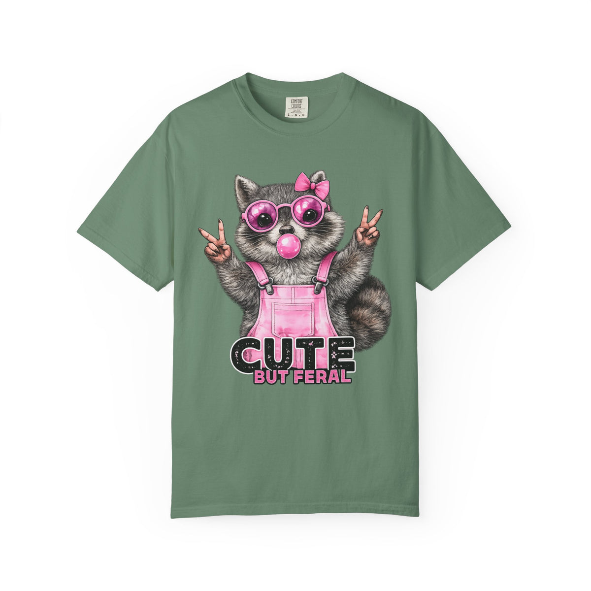 Cute But Feral, Raccoon in Pink Bibs - Comfort Colors | Trendy Women's T-Shirt. Direct to Garment. Printed & Shipped in the USA. Unisex Sizes.
