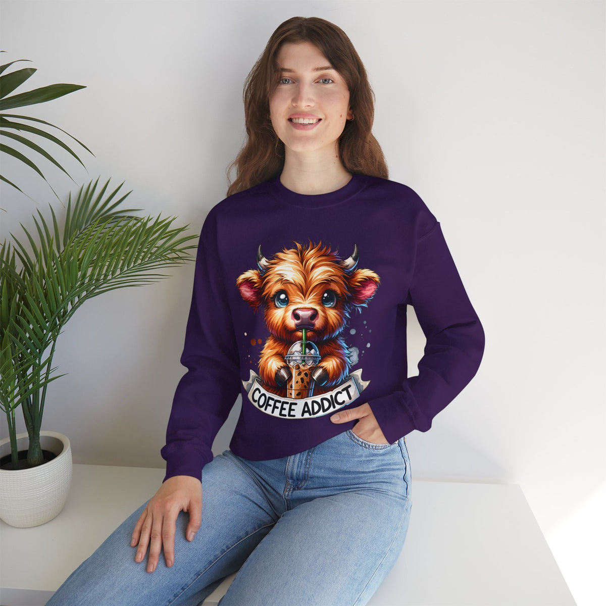 Coffee Addict Highland Cow Drinking Iced Coffee – Gildan Heavy Blend | Trendy Women’s Soft Sweatshirt. Direct to Garment. Printed & Shipped in the USA. Unisex Sizes.