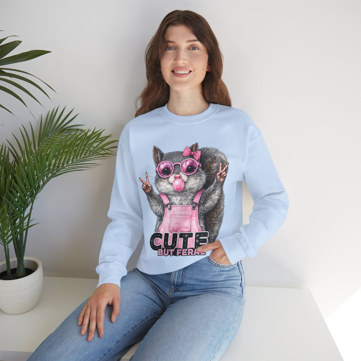 Cute But Feral, Squirrel in Pink Bibs – Gildan Heavy Blend | Trendy Women’s Soft Sweatshirt. Direct to Garment. Printed & Shipped in the USA. Unisex Sizes.