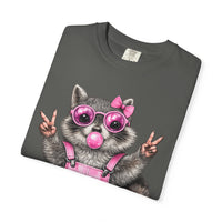 Cute But Feral, Raccoon in Pink Bibs - Comfort Colors | Trendy Women's T-Shirt. Direct to Garment. Printed & Shipped in the USA. Unisex Sizes.