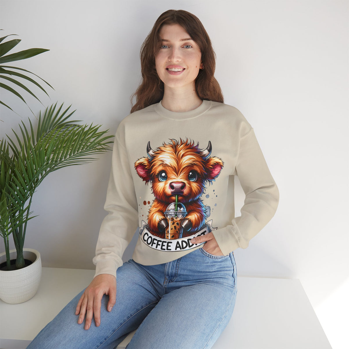 Coffee Addict Highland Cow Drinking Iced Coffee – Gildan Heavy Blend | Trendy Women’s Soft Sweatshirt. Direct to Garment. Printed & Shipped in the USA. Unisex Sizes.