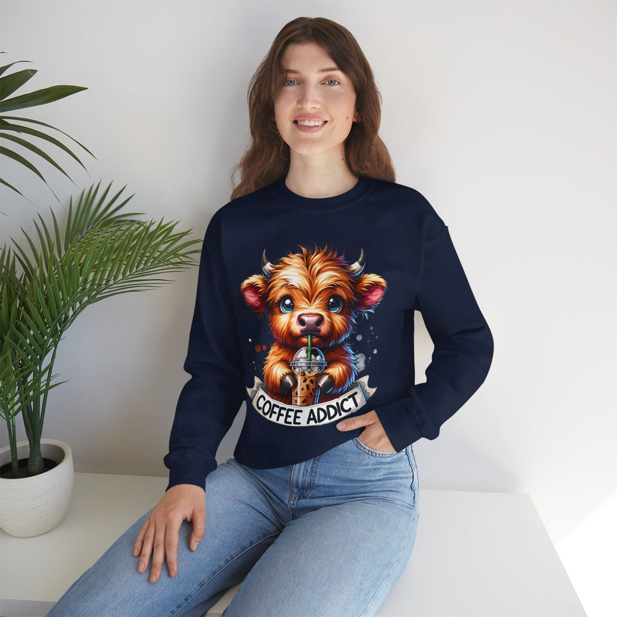 Coffee Addict Highland Cow Drinking Iced Coffee – Gildan Heavy Blend | Trendy Women’s Soft Sweatshirt. Direct to Garment. Printed & Shipped in the USA. Unisex Sizes.