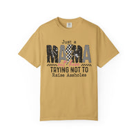 Just a Mama Out Here Trying Not To Raise Assholes - Comfort Colors | Trendy Women's T-Shirt. Direct to Garment. Printed & Shipped in the USA. Unisex Sizes.
