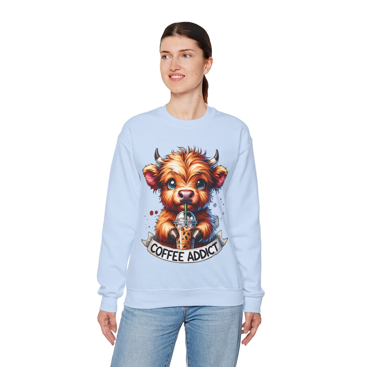 Coffee Addict Highland Cow Drinking Iced Coffee – Gildan Heavy Blend | Trendy Women’s Soft Sweatshirt. Direct to Garment. Printed & Shipped in the USA. Unisex Sizes.