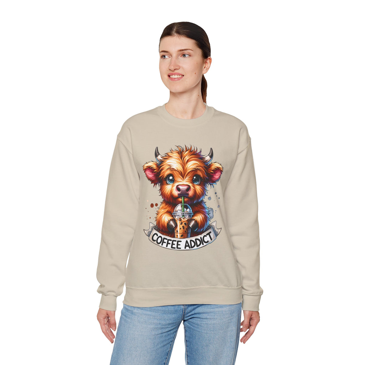 Coffee Addict Highland Cow Drinking Iced Coffee – Gildan Heavy Blend | Trendy Women’s Soft Sweatshirt. Direct to Garment. Printed & Shipped in the USA. Unisex Sizes.