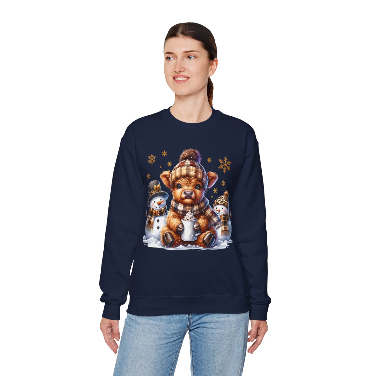 Cute Highland Cow with Snowmen, Winter – Gildan Heavy Blend | Trendy Women’s Soft Sweatshirt. Direct to Garment. Printed & Shipped in the USA. Unisex Sizes.