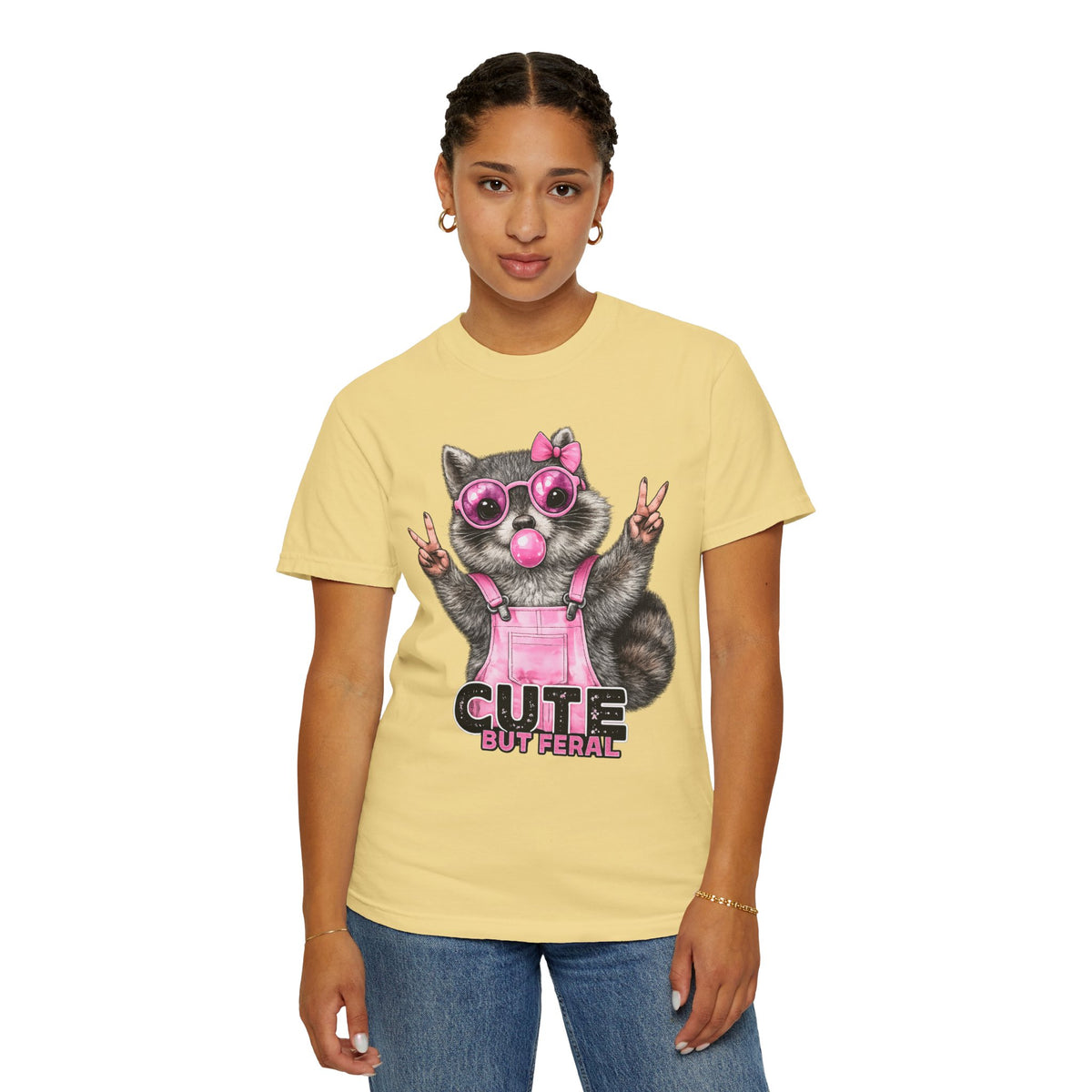 Cute But Feral, Raccoon in Pink Bibs - Comfort Colors | Trendy Women's T-Shirt. Direct to Garment. Printed & Shipped in the USA. Unisex Sizes.