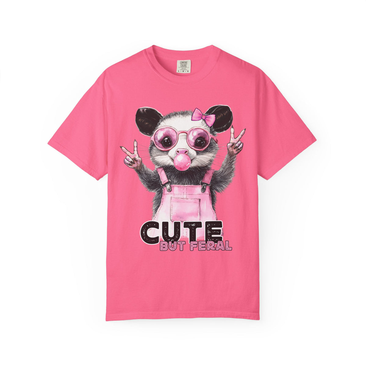 Cute But Feral, Possum in Pink Bibs - Comfort Colors | Trendy Women's T-Shirt. Direct to Garment. Printed & Shipped in the USA. Unisex Sizes.