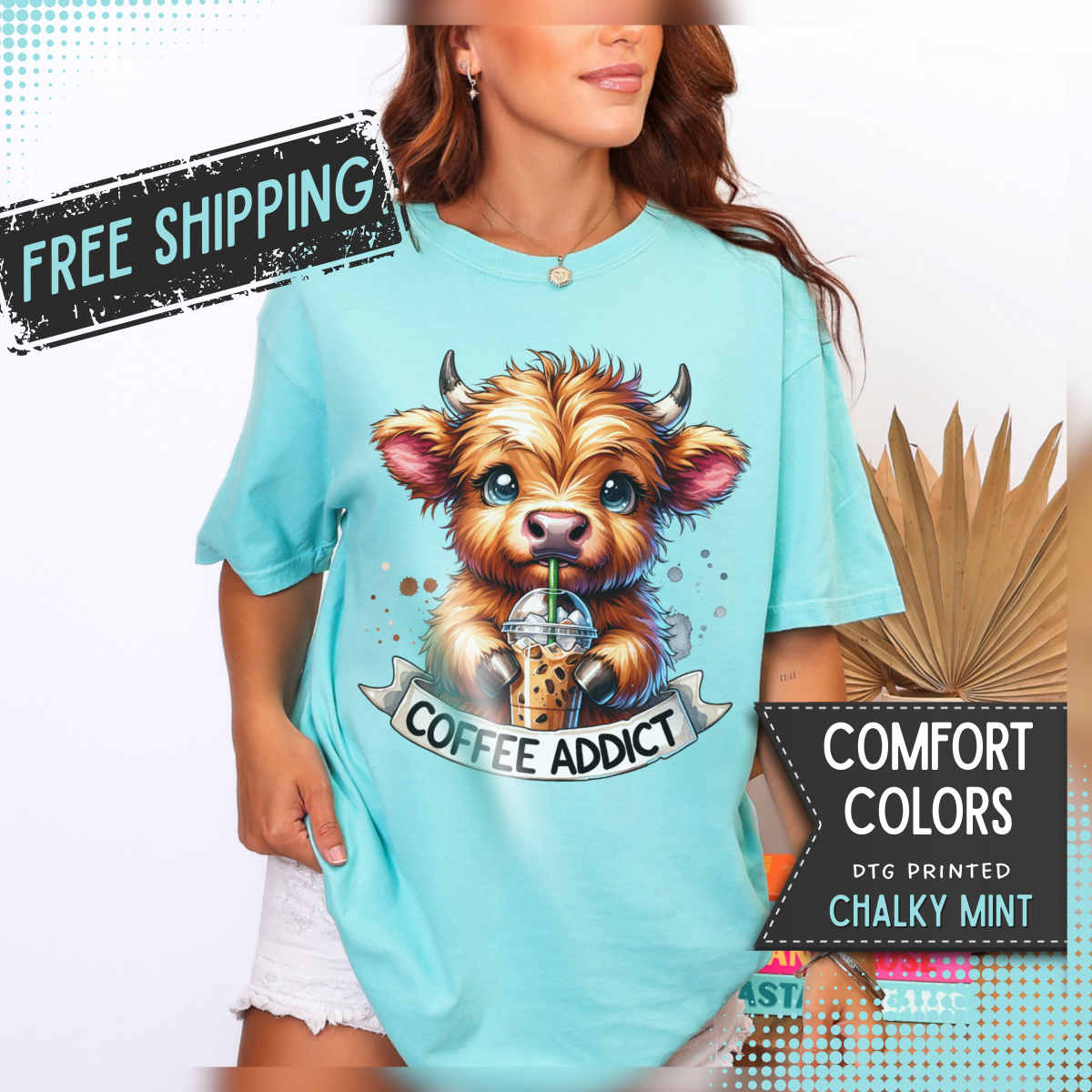 Coffee Addict Highland Cow Drinking Iced Coffee - Comfort Colors | Trendy Women's T-Shirt. Direct to Garment. Printed & Shipped in the USA. Unisex Sizes.