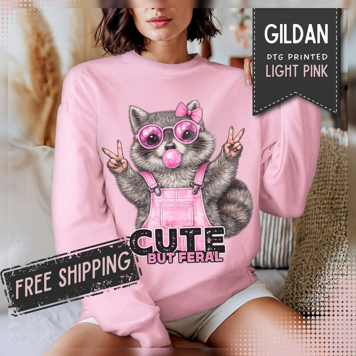 Cute But Feral, Raccoon in Pink Bibs – Gildan Heavy Blend | Trendy Women’s Soft Sweatshirt. Direct to Garment. Printed & Shipped in the USA. Unisex Sizes.