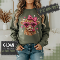 Highland Cow - Pink Heart Shaped Glasses – Gildan Heavy Blend | Trendy Women’s Soft Sweatshirt. Direct to Garment. Printed & Shipped in the USA. Unisex Sizes.