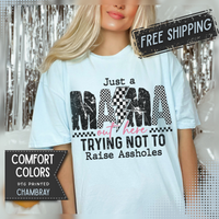 Just a Mama Out Here Trying Not To Raise Assholes - Comfort Colors | Trendy Women's T-Shirt. Direct to Garment. Printed & Shipped in the USA. Unisex Sizes.